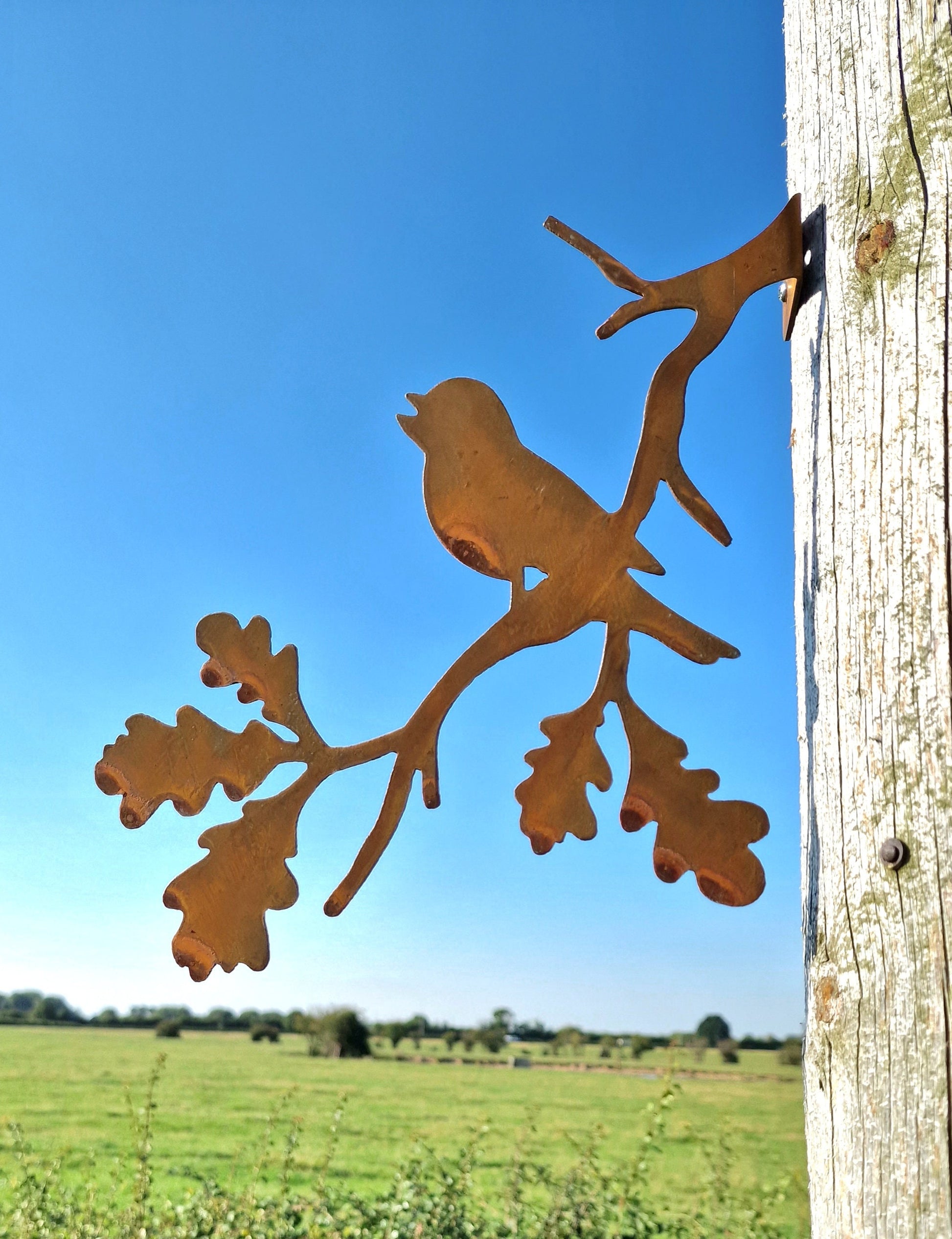 Rusted Metal Robin Singing On a Branch